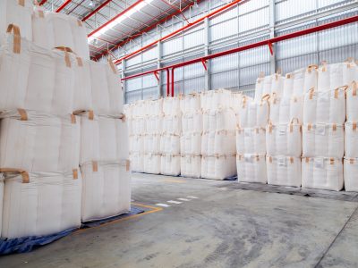 Stacking of bulk cargo in jumbo bags are store in warehouse for distribution to customer, import export logistics business.