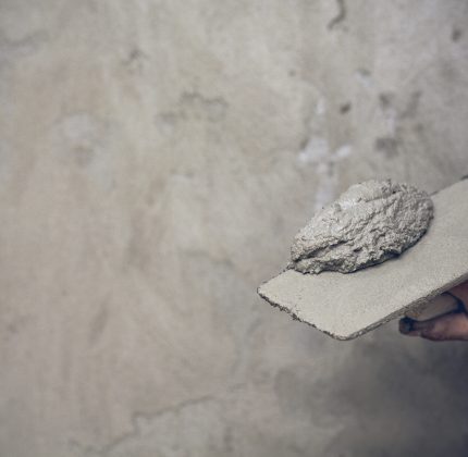 Plasterer renovating indoor walls.